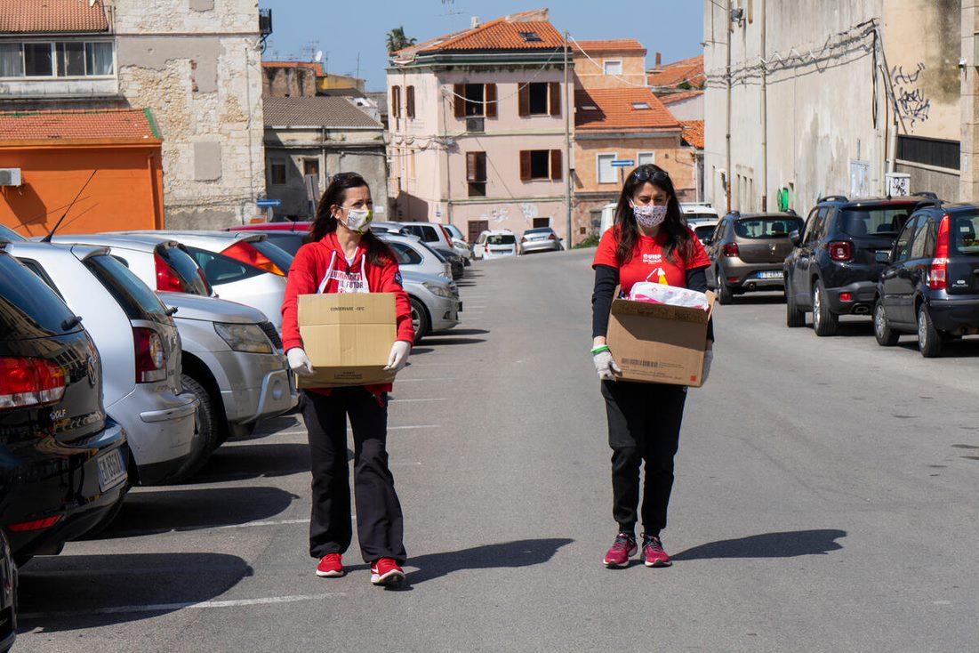 Image of volunteers carrying care kits
